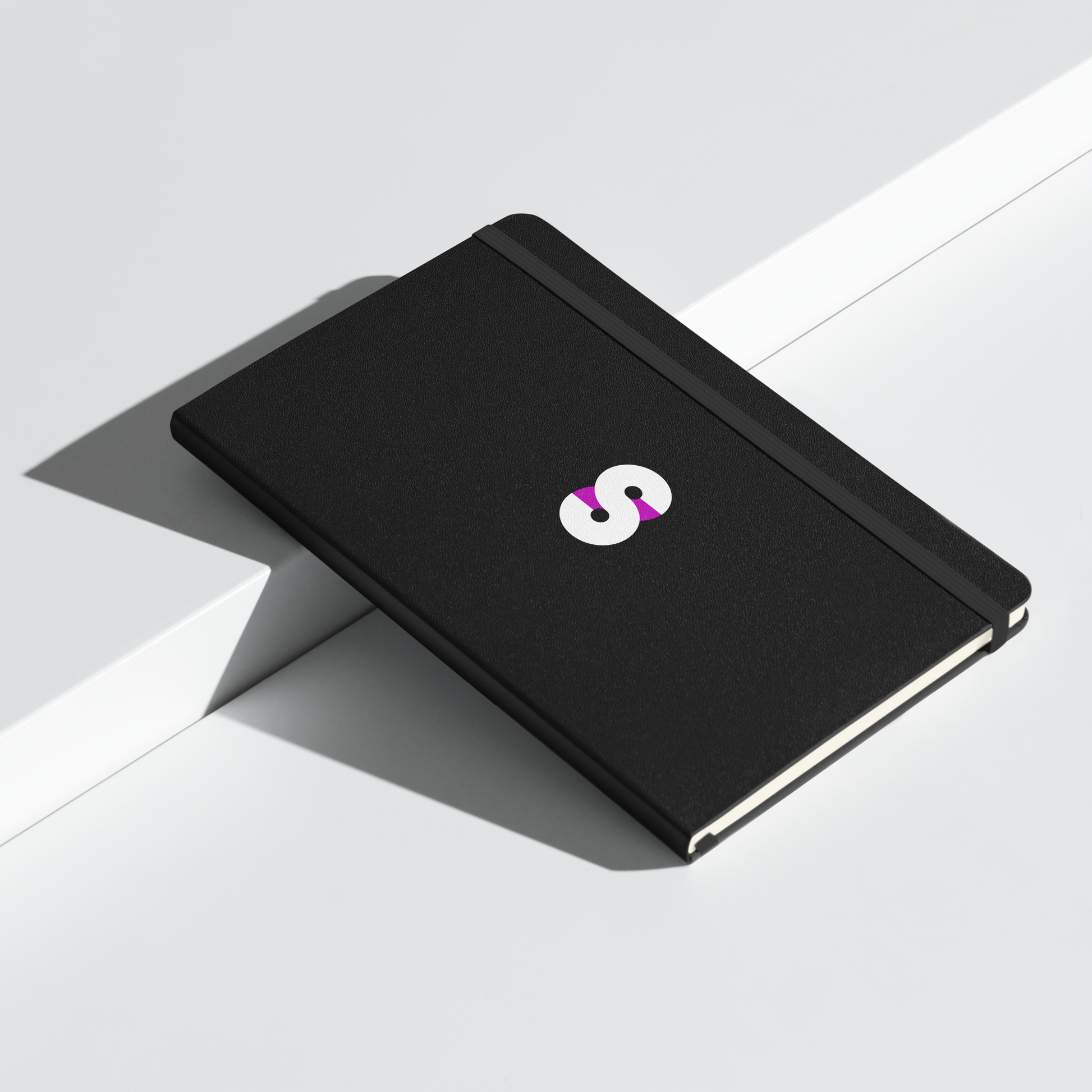 Cuaderno de Tapa Dura VOOM — The Archive Code con cubierta negra, logo central y cierre elástico en composición minimalista.